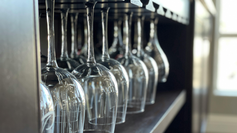 Wine glasses on a rack.