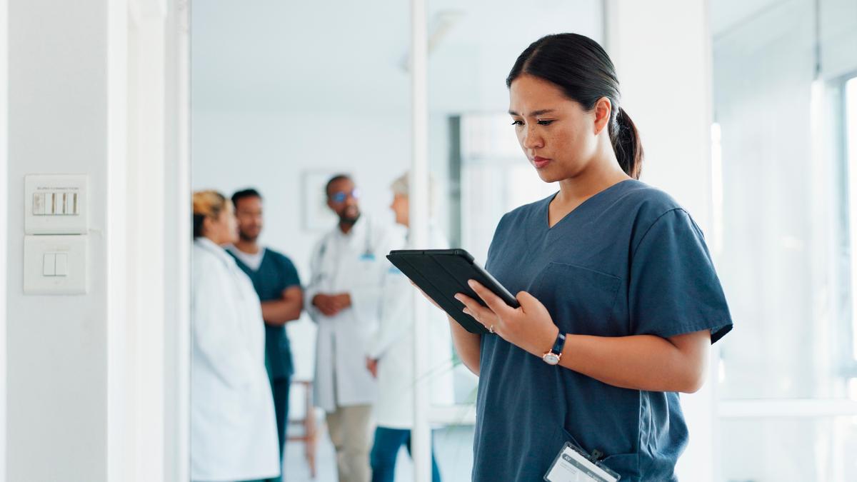 Nurse is using a tablet.