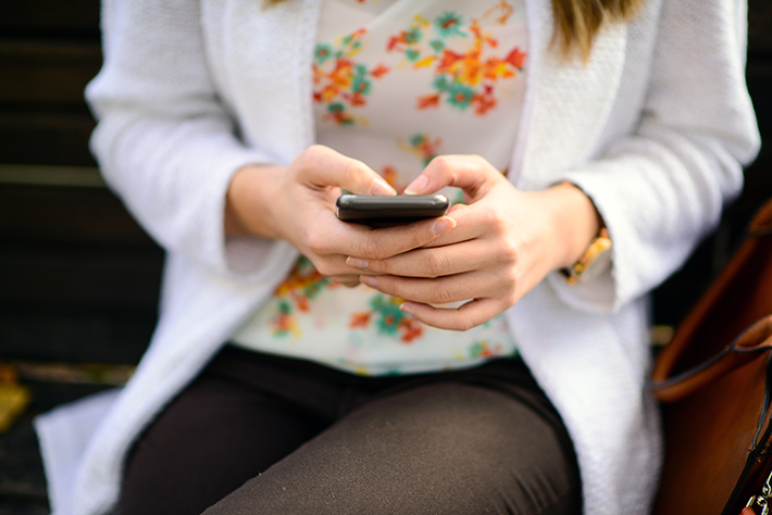 Person browses mobile phone.