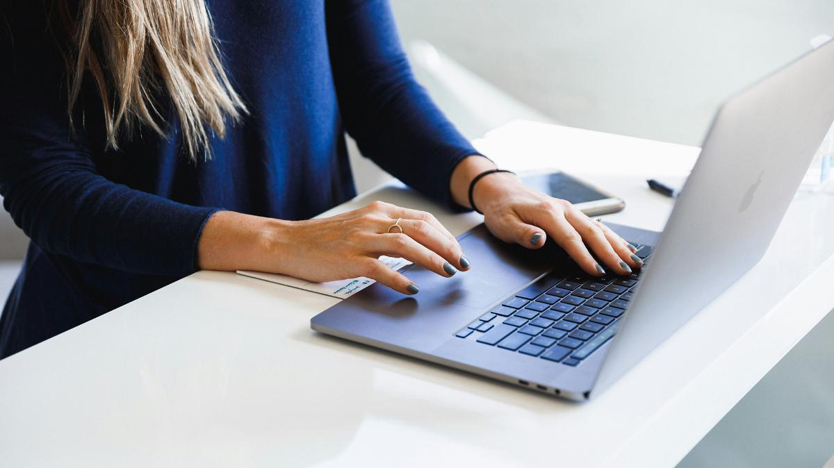 Person's hands on keyboard.